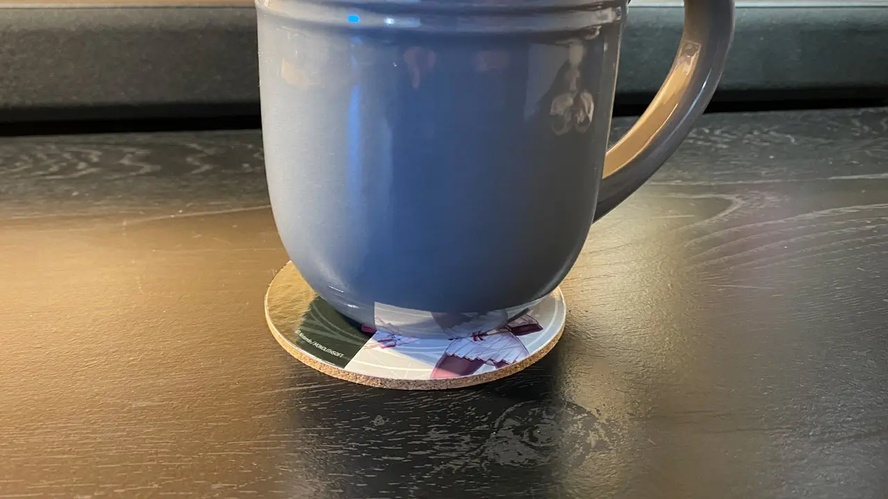 a mug on top of the coaster; coaster being used