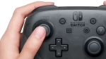 hand holding nintendo switch pro controller