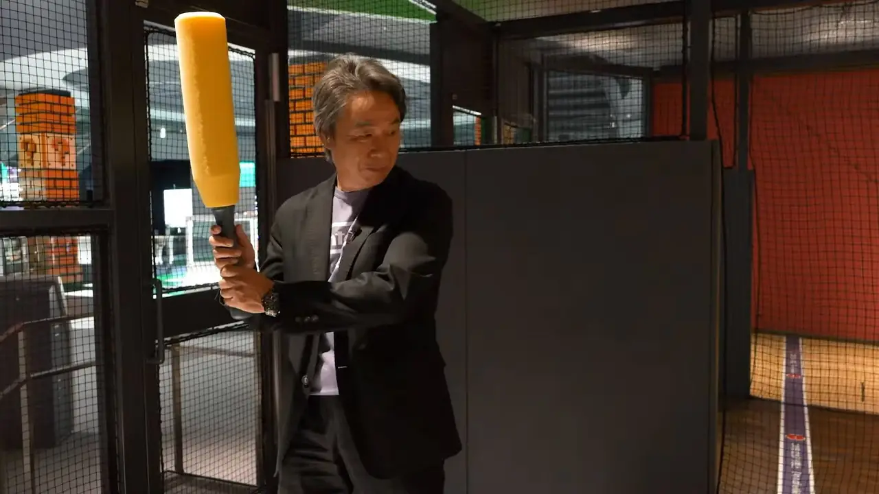 Nintendo Museum's batting cage with a man preparing to swing a bat