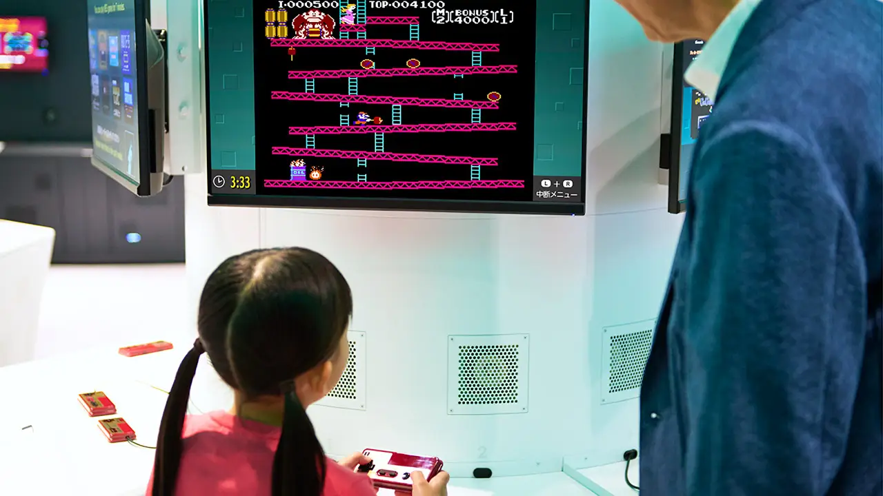 a girl playing donkey kong an a television set
