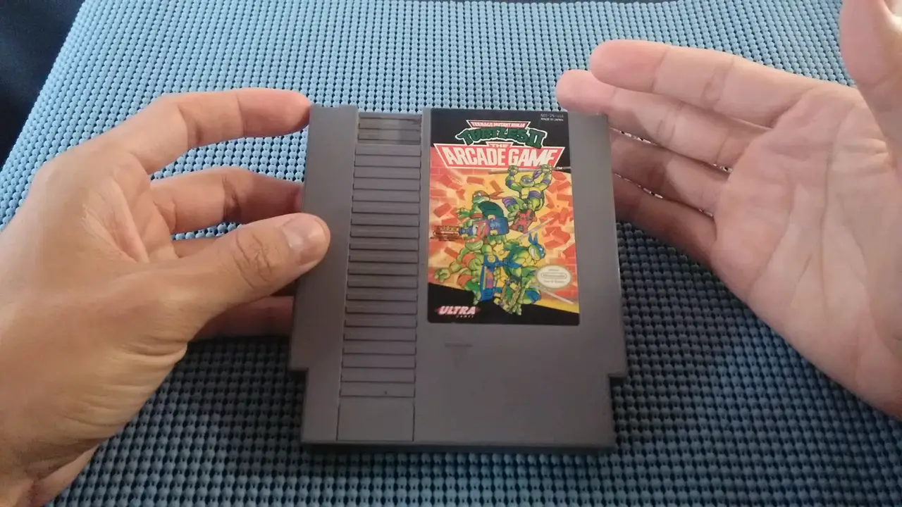 wally's hands holding a nes cartridge