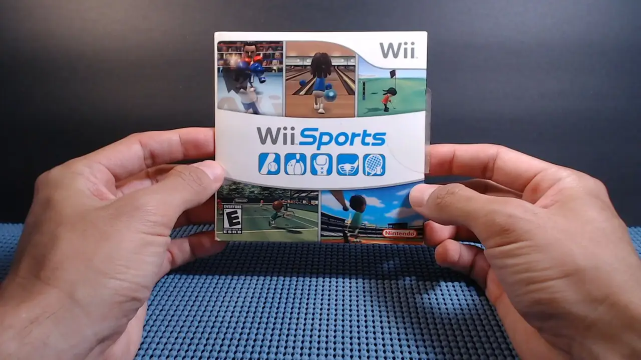 wally's hands holding a nintendo wii case